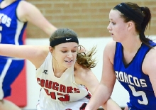 Sandy Creek senior Krista Johnson attempts to steal the ball during the Lady Cougars’ 48-18 win over Centennial in Southern Nebraska Conference play in the Cougars’ Den Dec. 11.